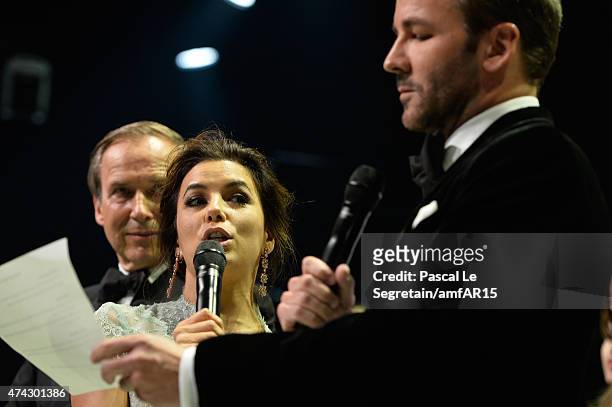 Auctioneer Simon De Pury, Actress Eva Longoria and fashion designer Tom Ford onstage during the fashion show runway during amfAR's 22nd Cinema...
