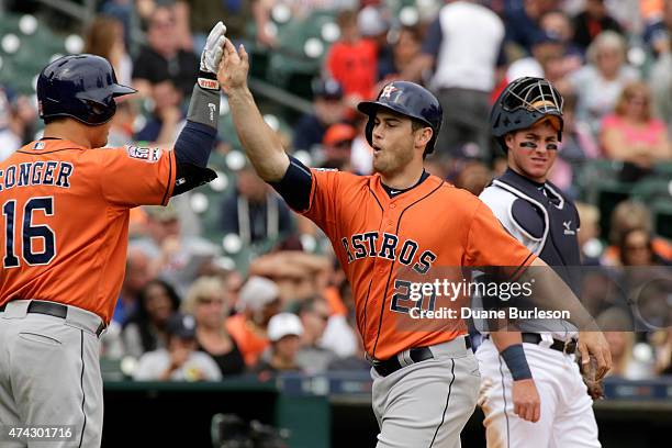 Preston Tucker of the Houston Astros is congratulated by Hank Conger of the Houston Astros after hitting his first major league home run to tie the...