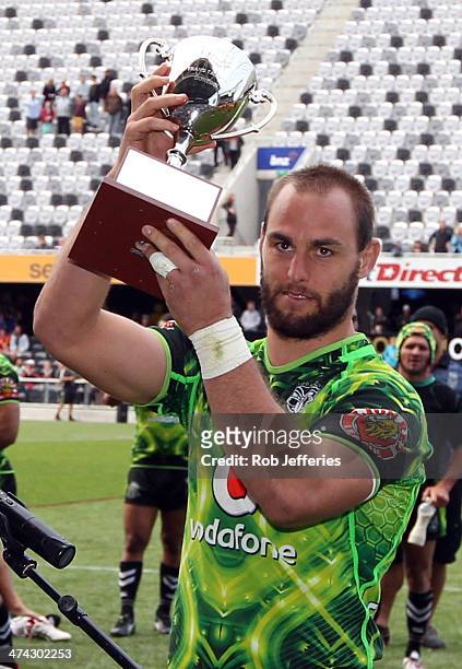 Simon Mannering, Captain of the Warriors holds up the TransTasman Cup after defeating the Brisbane Broncos during the NRL trial match between the...