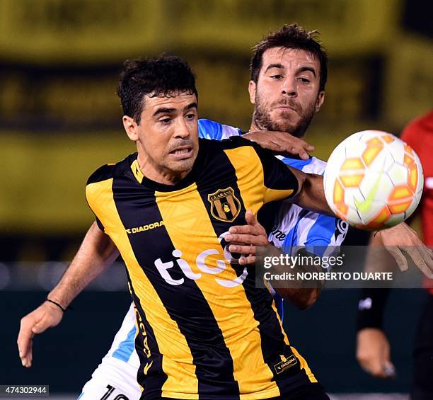 Julian Benitez of Paraguay's Guarani vies for the ball with Francisco Cerro, of Argentina's Racing, during their Libertadores Cup quarterfinal first...