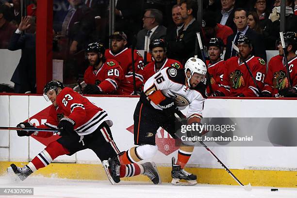 Emerson Etem of the Anaheim Ducks skates with the puck in the first period as Kris Versteeg of the Chicago Blackhawks defends in Game Three of the...