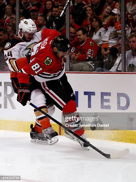 Marian Hossa of the Chicago Blackhawks tries to control the puck in the second period as Simon Despres of the Anaheim Ducks defends in Game Three of...