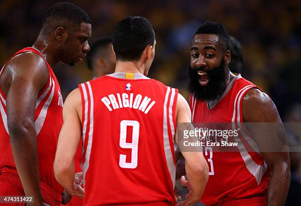 James Harden of the Houston Rockets reacts with teammates after a play in the first quarter against the Golden State Warriors during game two of the...