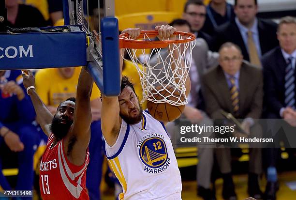 Andrew Bogut of the Golden State Warriors slam dunks against James Harden of the Houston Rockets during the first half in Game Two of the Western...