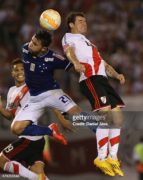 Eugenio Mena of Cruzeiro and Rodrigo Mora of River Plate go for a header during a first leg match between River Plate and Cruzeiro as part of...