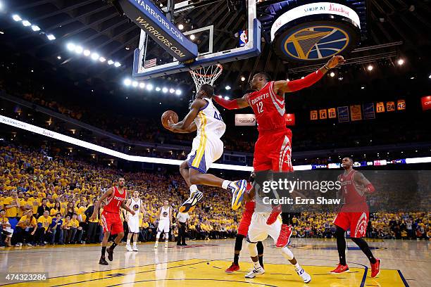 Harrison Barnes of the Golden State Warriors drives to the basket against Dwight Howard of the Houston Rockets in the second half during game two of...