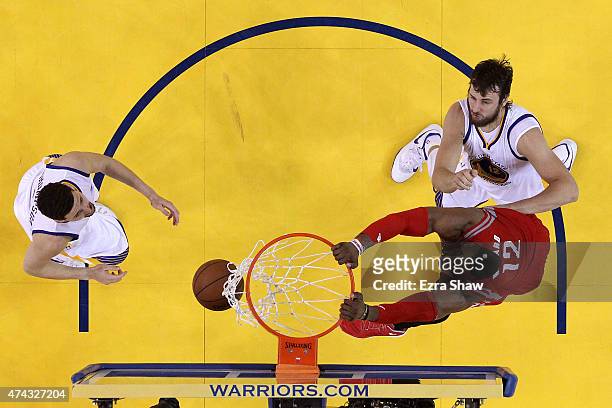 Dwight Howard of the Houston Rockets dunks in the second half against Klay Thompson and Andrew Bogut of the Golden State Warriors during game two of...