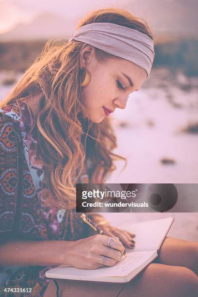 boho girl writing in her journal while surronded by nature - bohemia stock pictures, royalty-free photos & images