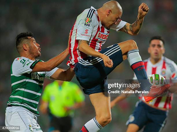 Jorge Enriquez of Chivas controls the ball over the mark of Javier Orozco of Santos during a semifinal first leg match between Santos Laguna and...