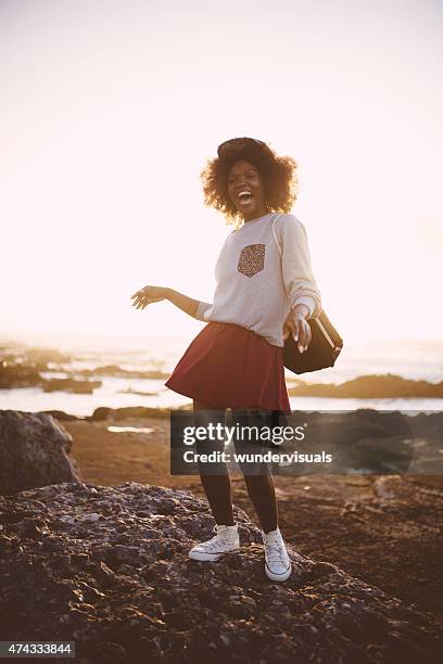 happy afro hipster teen girl posing joyfully at beach - african american teen stockfoto's en -beelden