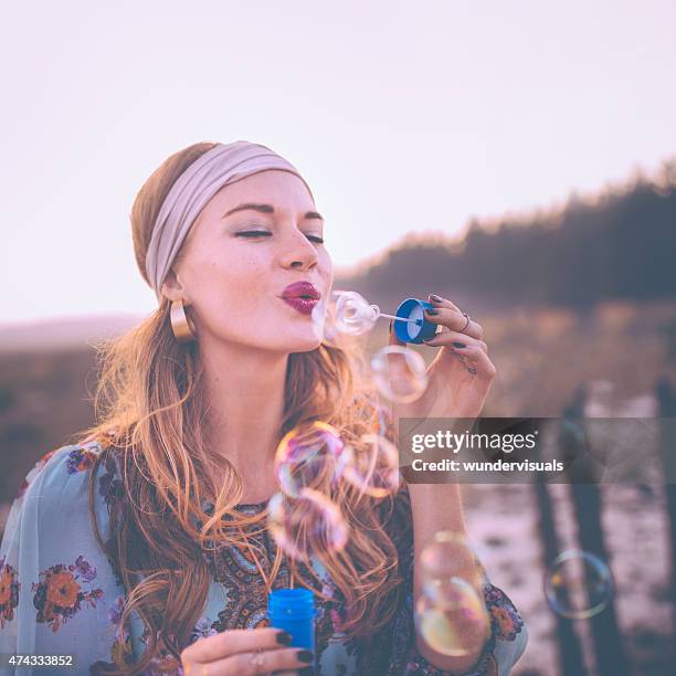 fashion boho girl blowing bubbles in nature - bohemia stock pictures, royalty-free photos & images