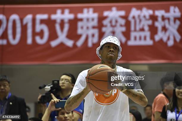 American retired professional basketball player Allen Iverson shows basketball during his visit on May 21, 2015 in Harbin, Heilongjiang Province of...