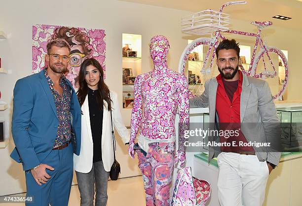 Designer Zachary Crane, actress Amanda Setton and designer Lorenzo Martone attend #UNCHAINME-An Art Bike Show By Martone Cycling Co. At Ron Robinson...