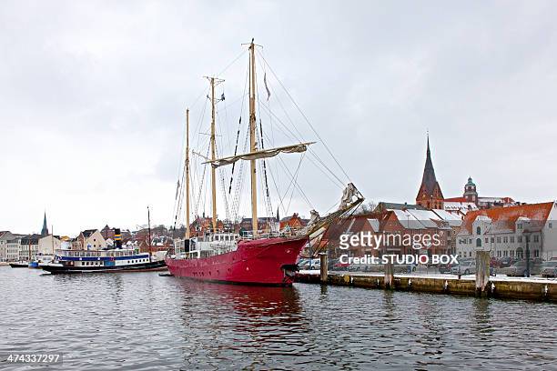 red ship docked at pier - flensburg stock pictures, royalty-free photos & images