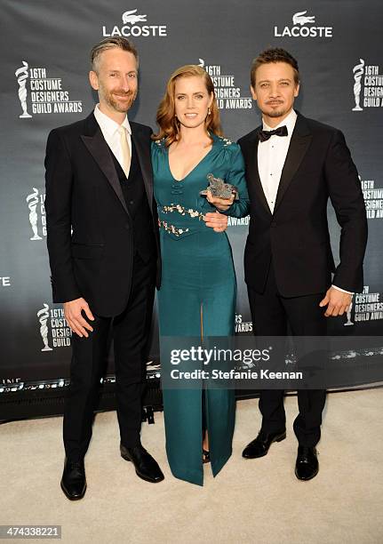 Costume designer Michael Wilkinson, actress Amy Adams and actor Jeremy Renner attend the 16th Costume Designers Guild Awards with presenting sponsor...