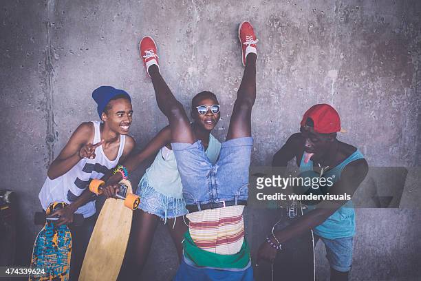 happy friends with longboards having fun with crazy poses - city to surf stock pictures, royalty-free photos & images