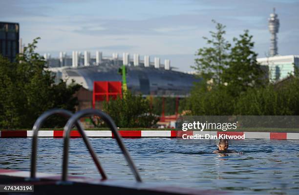 Woman swims in the new 'King's Cross Pond Club' outdoor swimming pool on May 22, 2015 in London, England. The 40 metre pool is purified using...