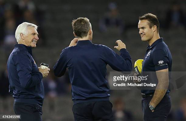 Blues head coach Michael Malthouse has a coffee in the warm up with assistants Dean Laidley and Brad Green during the round eight AFL match between...