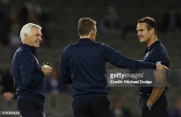 Blues head coach Michael Malthouse has a coffee in the warm up with assistants Dean Laidley and Brad Green during the round eight AFL match between...