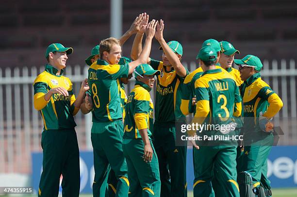 Juston Dill of South Africa celebrates the wicket of Usman Ghani of Afghanistan during the ICC U19 CWC Super League Quarter Final 3 match between...