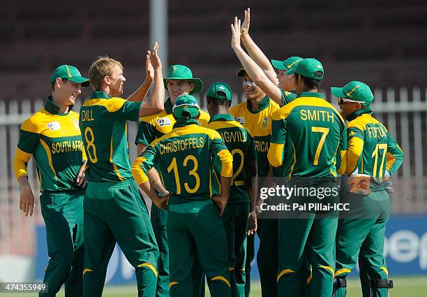 Juston Dill of South Africa celebrates the wicket of Usman Ghani of Afghanistan during the ICC U19 CWC Super League Quarter Final 3 match between...