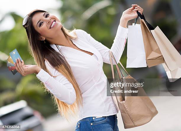 compras mujer sosteniendo tarjetas de crédito - tarjeta de lealtad fotografías e imágenes de stock