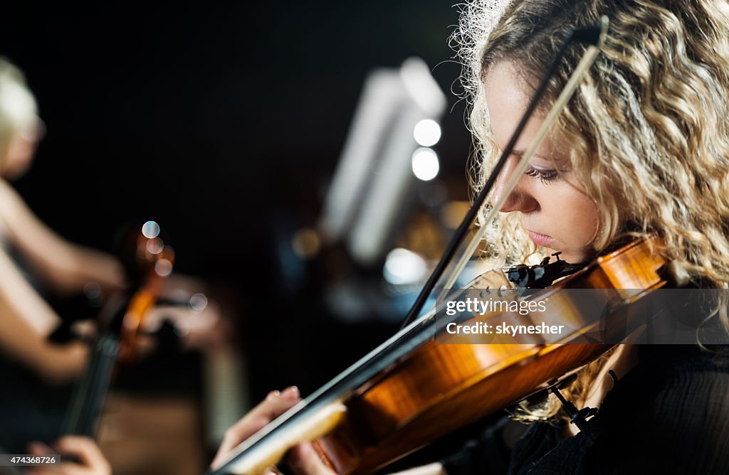 Woman playing the violin.