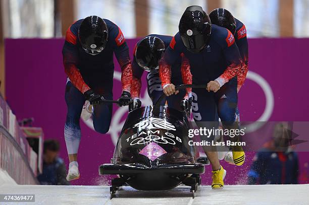 Pilot John James Jackson, Stuart Benson, Bruce Tasker and Joel Fearon of Great Britain team 1 make a run during the Men's Four-Man Bobsleigh on Day...