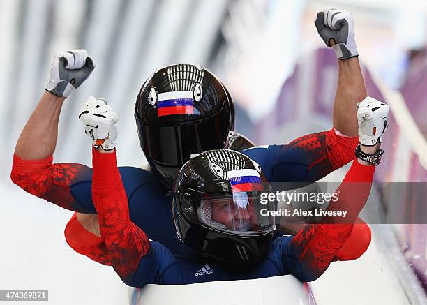 Pilot Alexander Zubkov, Alexey Negodaylo, Dmitry Trunenkov and Alexey Voevoda of Russia team 1 celebrate winning the gold medal during the Men's...