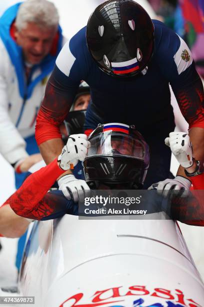 Pilot Alexander Zubkov, Alexey Negodaylo, Dmitry Trunenkov and Alexey Voevoda of Russia team 1 celebrate winning the gold medal during the Men's...