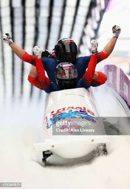 Pilot Alexander Zubkov, Alexey Negodaylo, Dmitry Trunenkov and Alexey Voevoda of Russia team 1 celebrate winning the gold medal during the Men's...