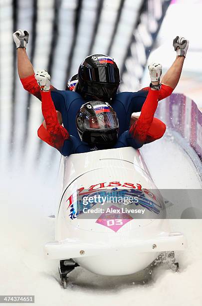 Pilot Alexander Zubkov, Alexey Negodaylo, Dmitry Trunenkov and Alexey Voevoda of Russia team 1 celebrate winning the gold medal during the Men's...