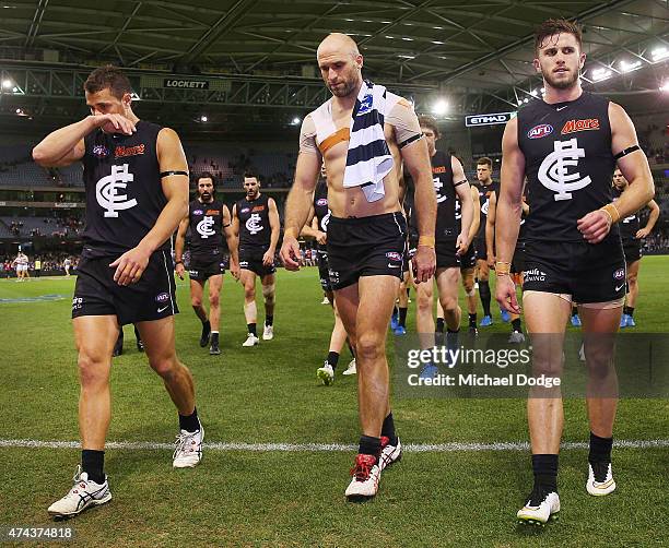 Ed Curnow Marc Murphy and Chris Judd of the Blues walks off after defeat with the jumper of Cameron Guthrie of the Cats during the round eight AFL...