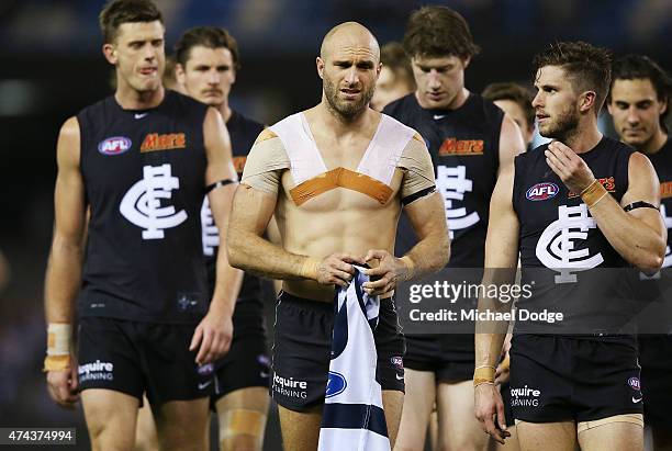 Marc Murphy of the Blues and Chris Judd of the Blues walks off after defeat with the jumper of Cameron Guthrie of the Cats during the round eight AFL...