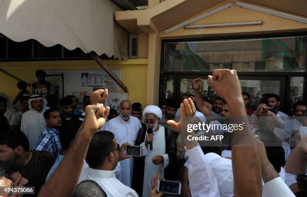 Saudi men chant slogans as a cleric addresses the group in the mainly Shiite Saudi Gulf coastal town of Qatif, 400 kms east of Riyadh, on May 22...