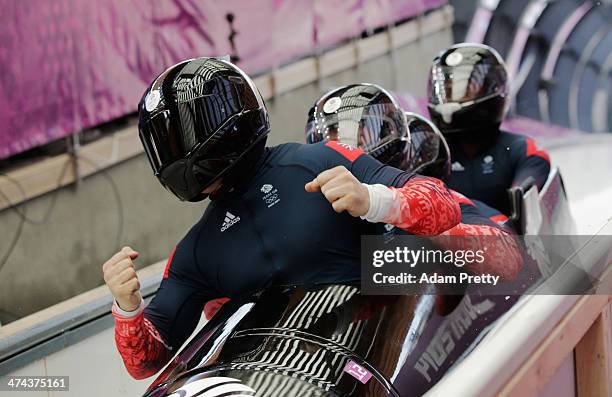 Pilot John James Jackson, Stuart Benson, Bruce Tasker and Joel Fearon of Great Britain team 1 react after a run during the Men's Four-Man Bobsleigh...