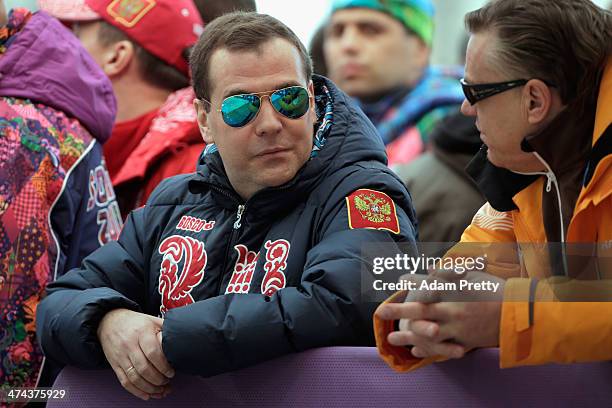 Russian Prime Minister Dmitry Medvedev and Latvia Bobsleigh team coach Zintis Ekmanis speak during the Men's Four-Man Bobsleigh on Day 16 of the...