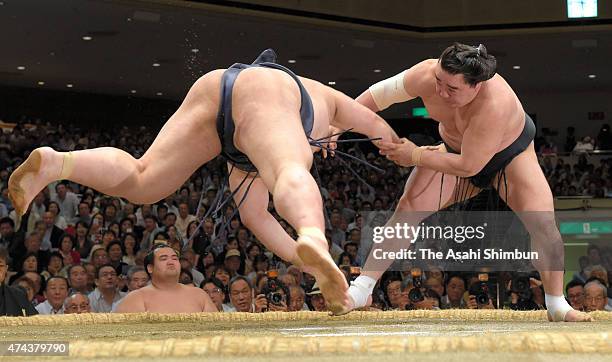 Mongolian yokozuna Harumafuji throws ozeki Kisenosato to win during day thirteen of the Grand Sumo Summer Tournament at Ryogoku Kokugikan on May 22,...