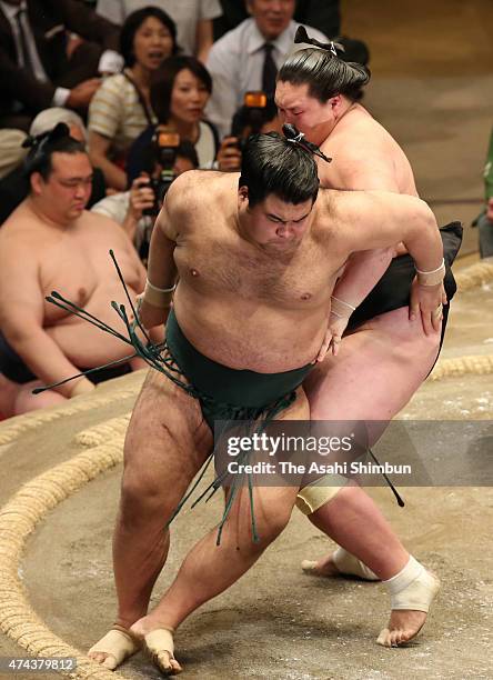 Mongolian sekiwake Terunofuji sends Takayasu out of the ring to win during day thirteen of the Grand Sumo Summer Tournament at Ryogoku Kokugikan on...