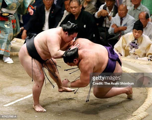 Ozeki Goeido throws Brazilian wrestler Kaisei to win during day thirteen of the Grand Sumo Summer Tournament at Ryogoku Kokugikan on May 22, 2015 in...