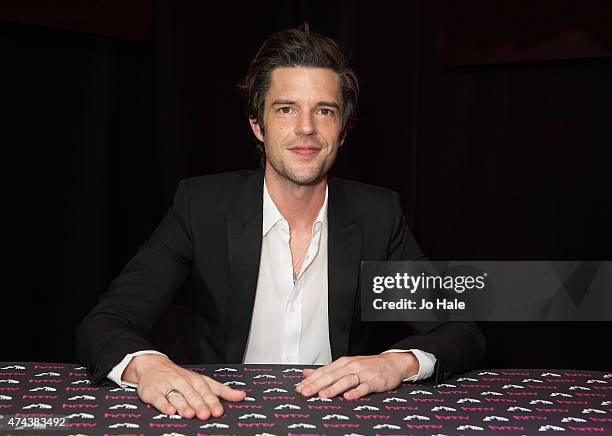 Brandon Flowers poses and signs copies of his New Album 'The Desired Effect' for Fans at at HMV Oxford Street on May 22, 2015 in London, England.