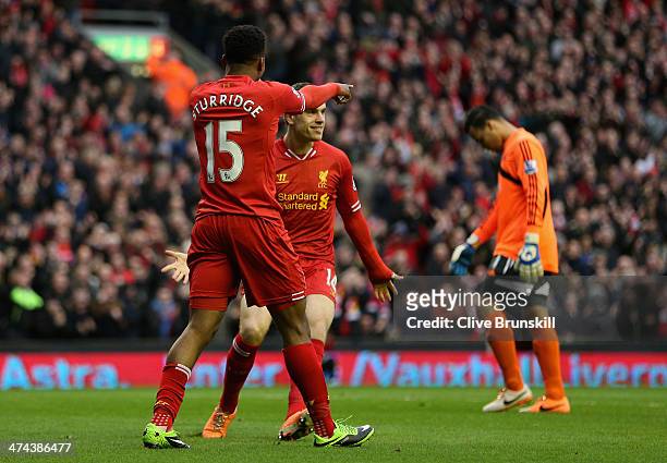 Daniel Sturridge of Liverpool celebrates scoring the first goal with Jordan Henderson during the Barclays Premier League match between Liverpool and...