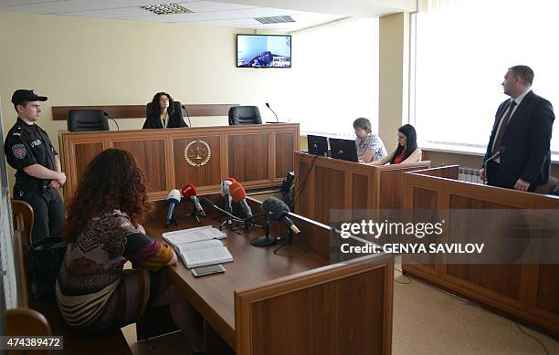 Judge of a Kiev's district court listens to participants of a trial by videoconference from a hospital in Kiev of a captured Russian soldier on May...