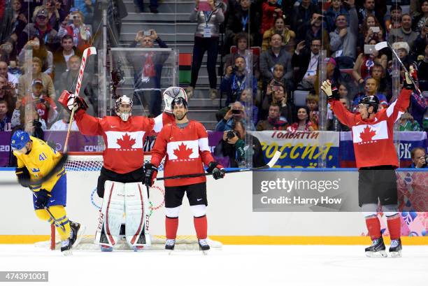 Carey Price, Dan Hamhuis and Jonathan Toews of Canada celebrate after defeating Sweden 3-0 during the Men's Ice Hockey Gold Medal match on Day 16 of...