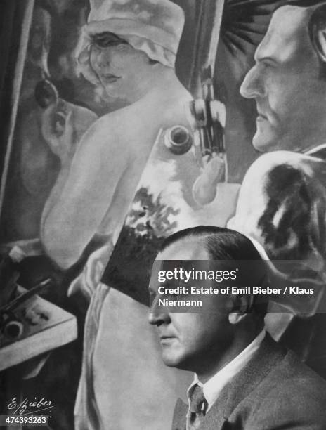 German-American artist George Grosz with his 1928 painting 'Artist and Model', circa 1930.