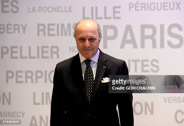 French Foreign Minister Laurent Fabius poses for a portrait at a gathering of former Chinese students who studied in France, as part of the...