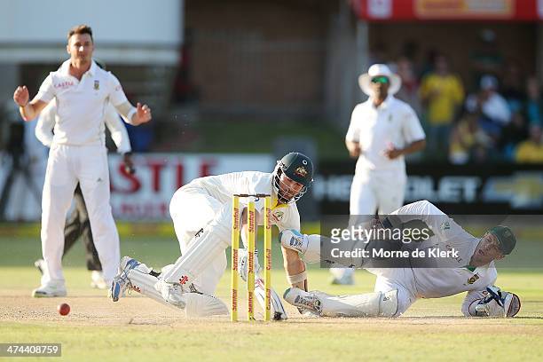 De Villiers of South Africa attempts to run-out Ryan Harris of Australia during day four of the Second Test match between South Africa and Australia...