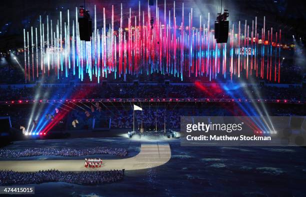 The Russian flag is brought into the arena by Russian athletes during the 2014 Sochi Winter Olympics Closing Ceremony at Fisht Olympic Stadium on...