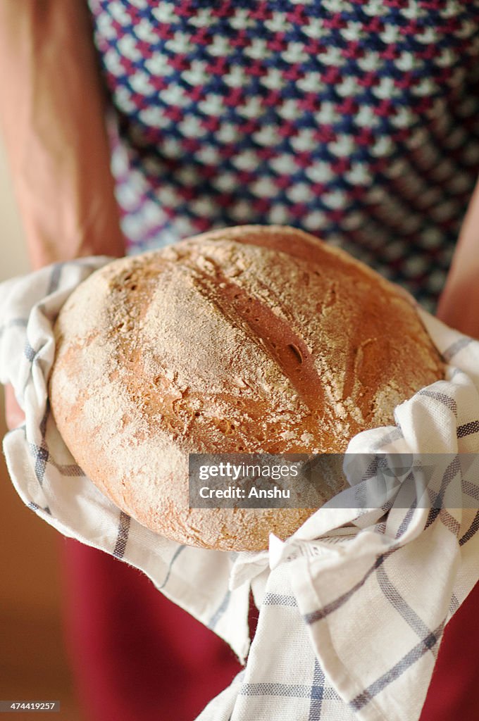 Boy holding a fresh Sourdough Bread