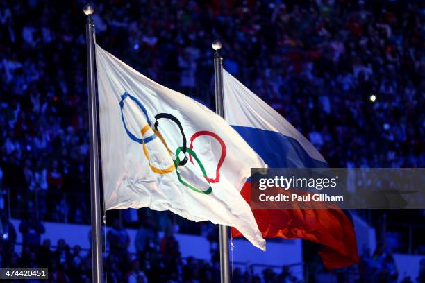 The Olympic flag and Russian flag are raised as the Russian National Anthem is sung during the 2014 Sochi Winter Olympics Closing Ceremony at Fisht...